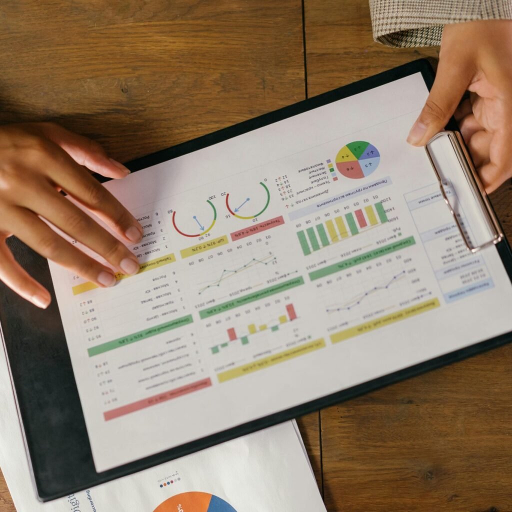 Top view of hands holding a financial report with colorful graphs and charts, ideal for business presentations.